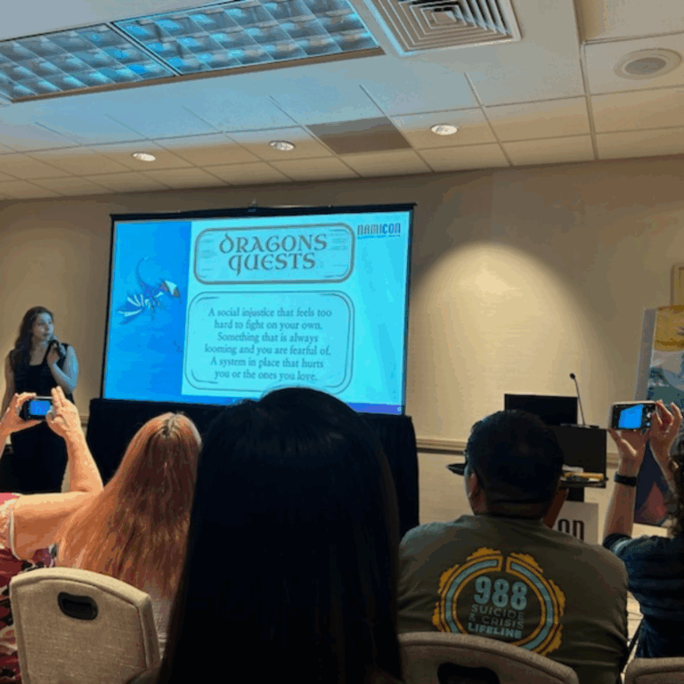 Sierra speaking by a slide that says "Dragon Quests"